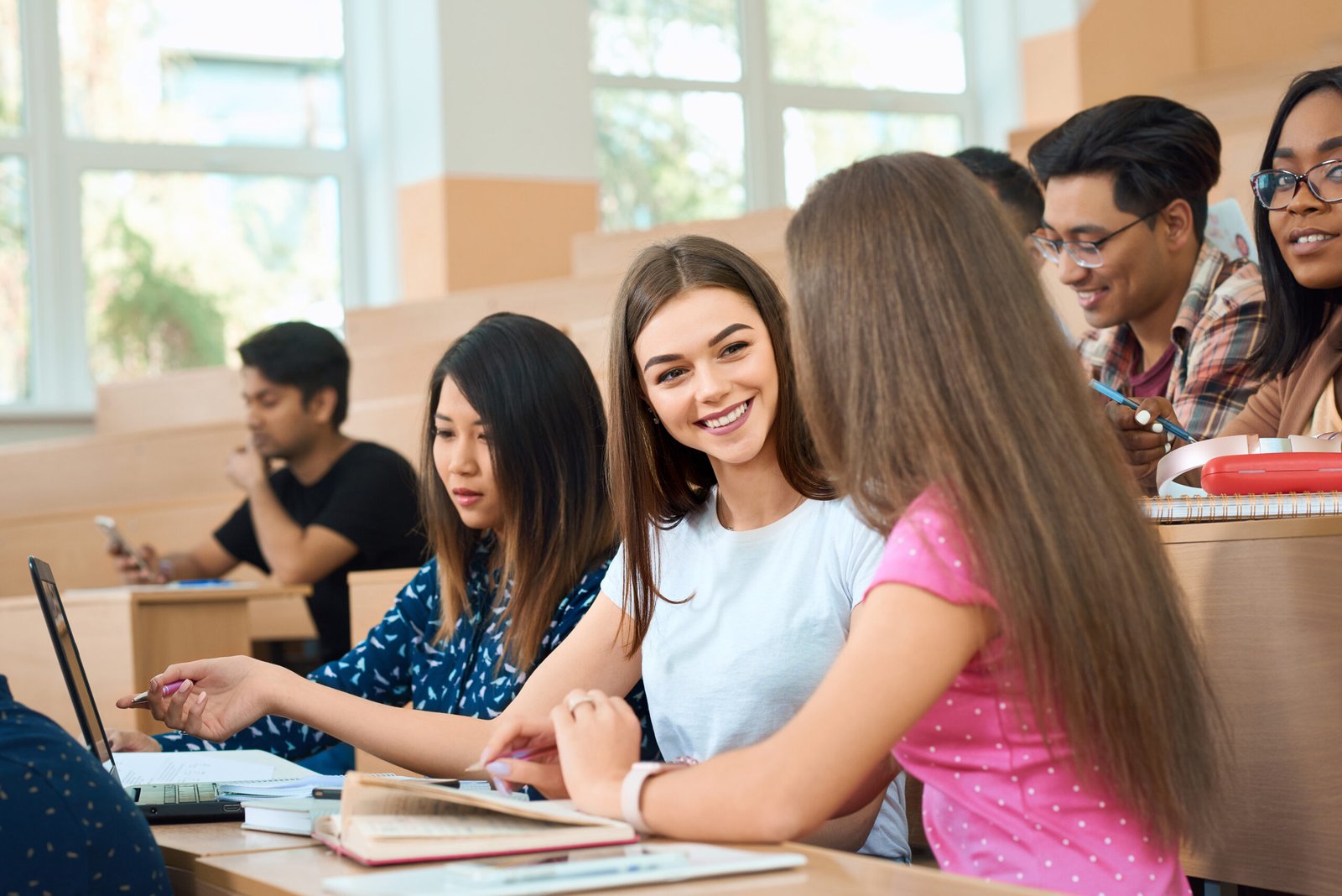 smiling students talking during lesson.
